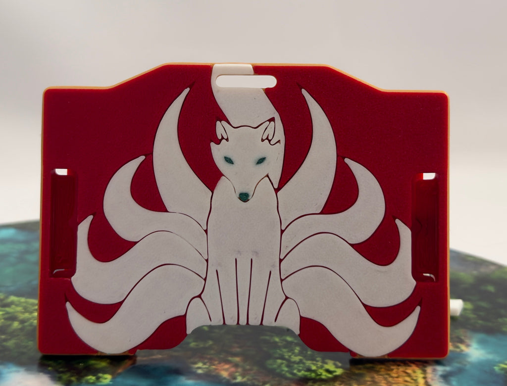 A red keycard holder featuring a white Kitsune fox design on the front